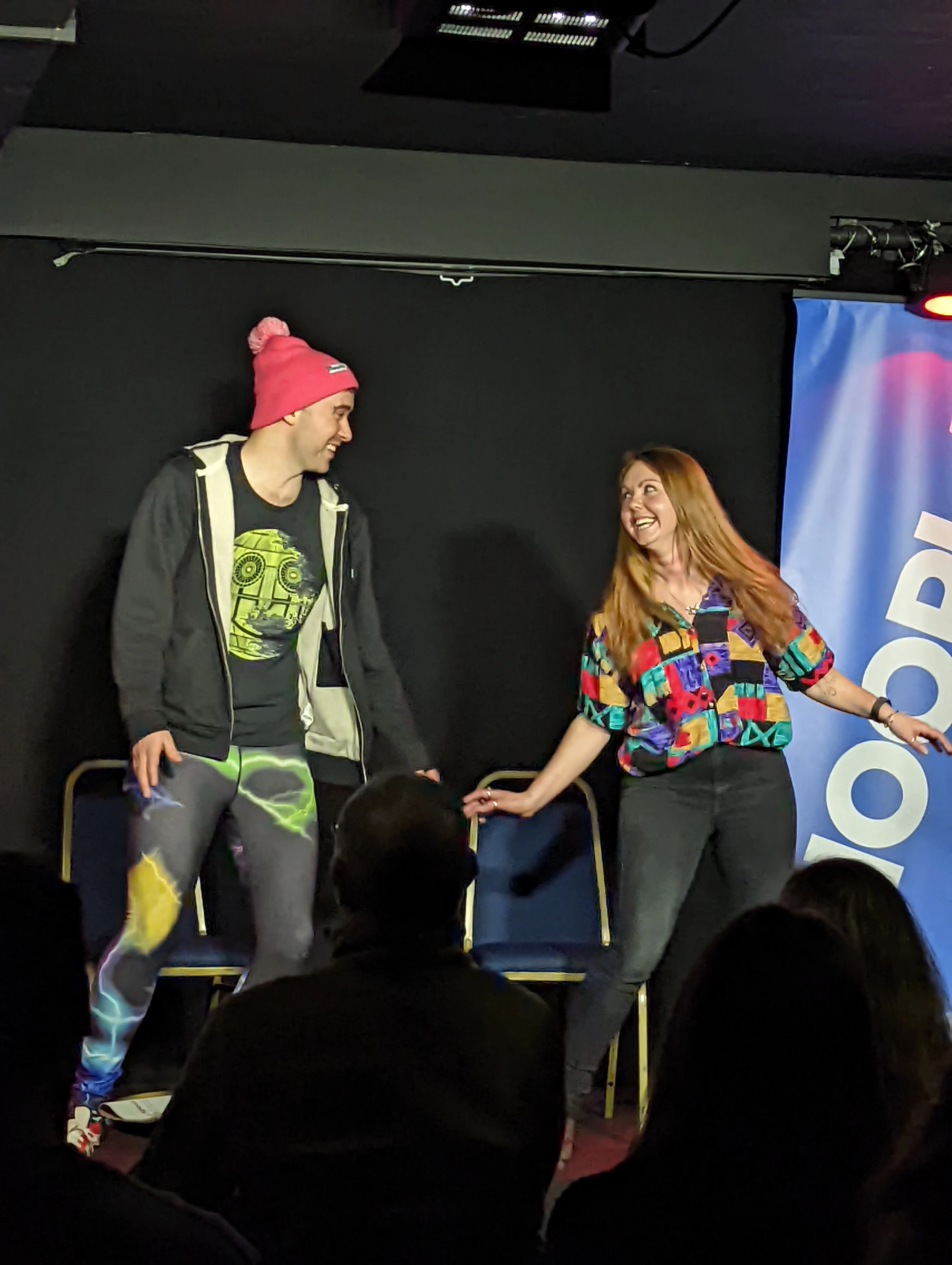 Charlie Jackson and Viki Jackson on stage performing improv comedy