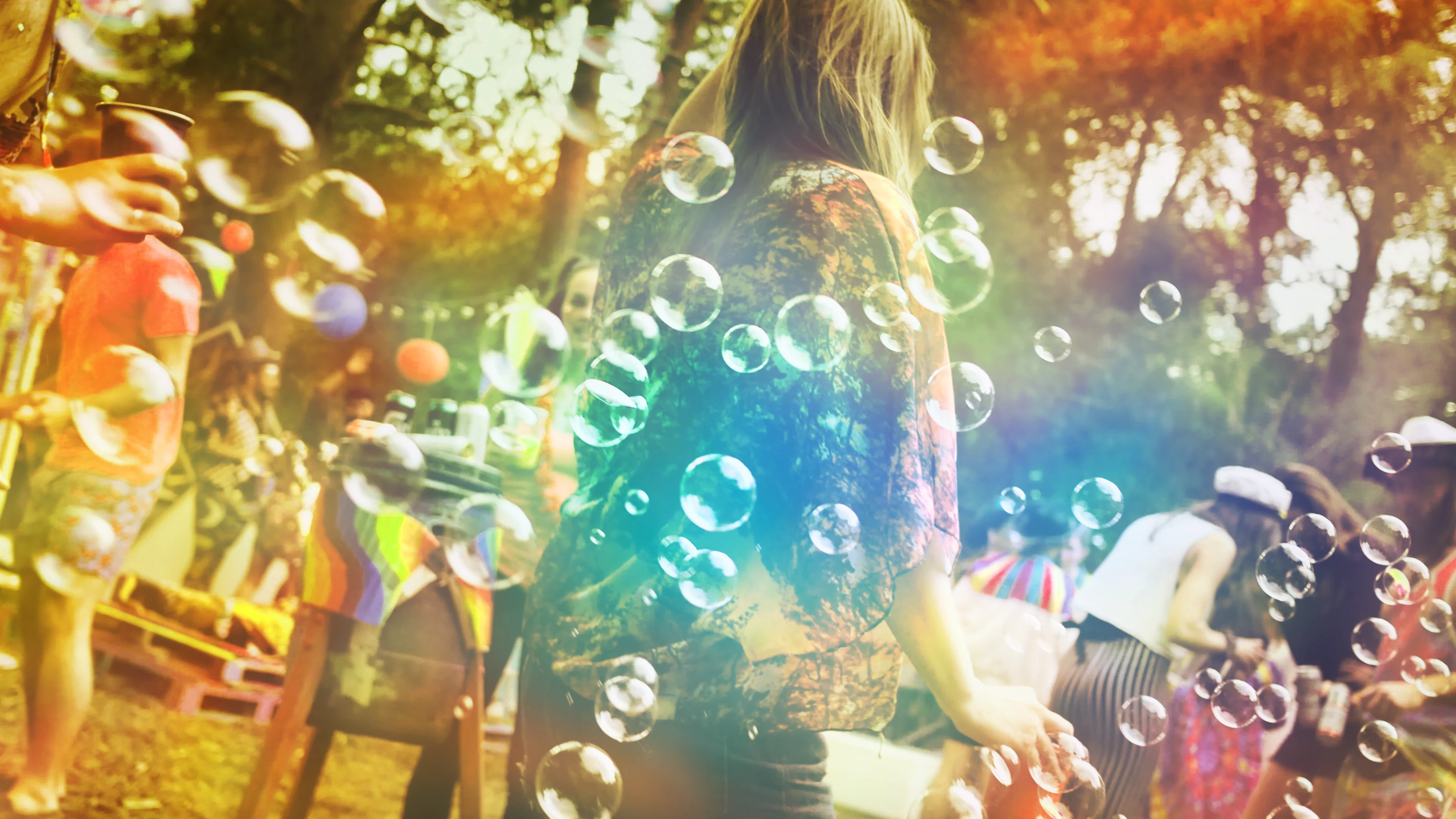 Wood Bubbles play image Playful image off bubbles flowing across a people in a woodland