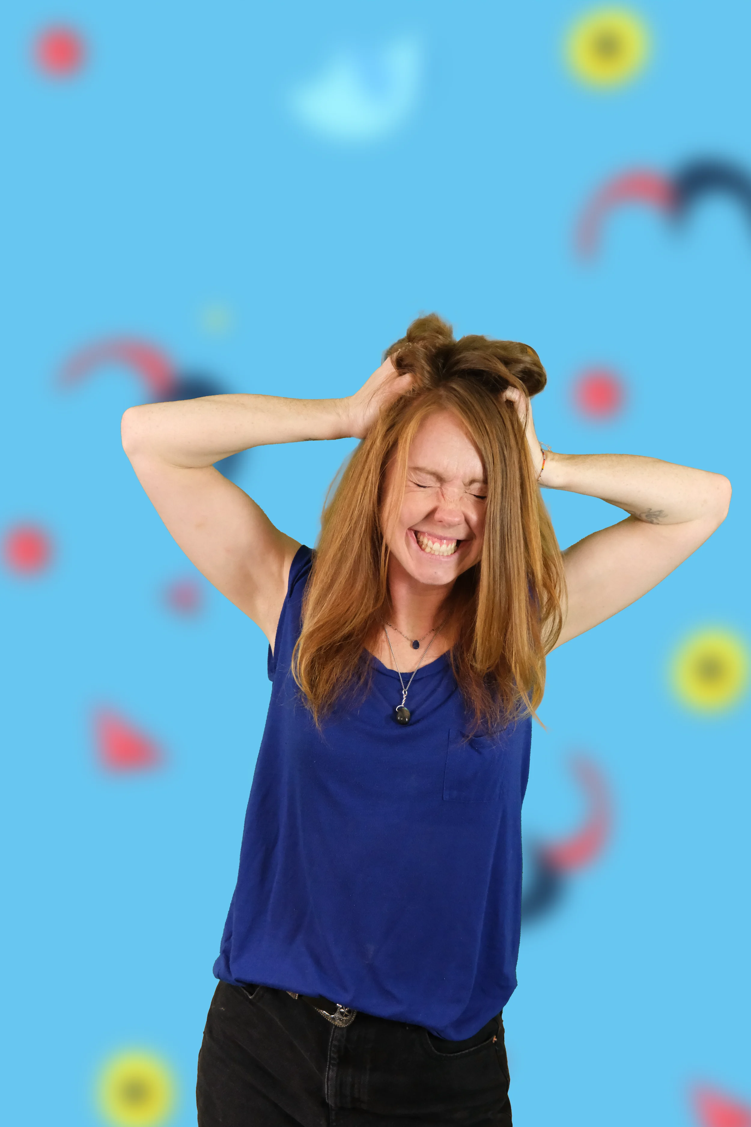 Image of a woman scrunching her hair and grinning 