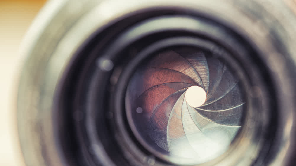 Close up of a camera lens signifying aperture - What is aperture - Clipchamp Blog