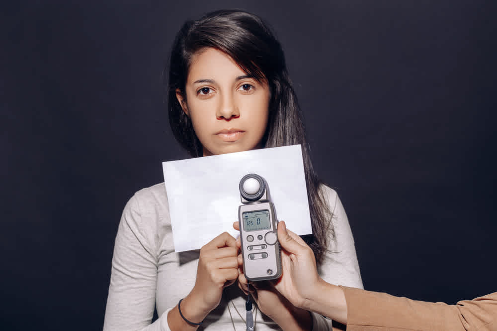 Young woman in studio lighted by footcandles