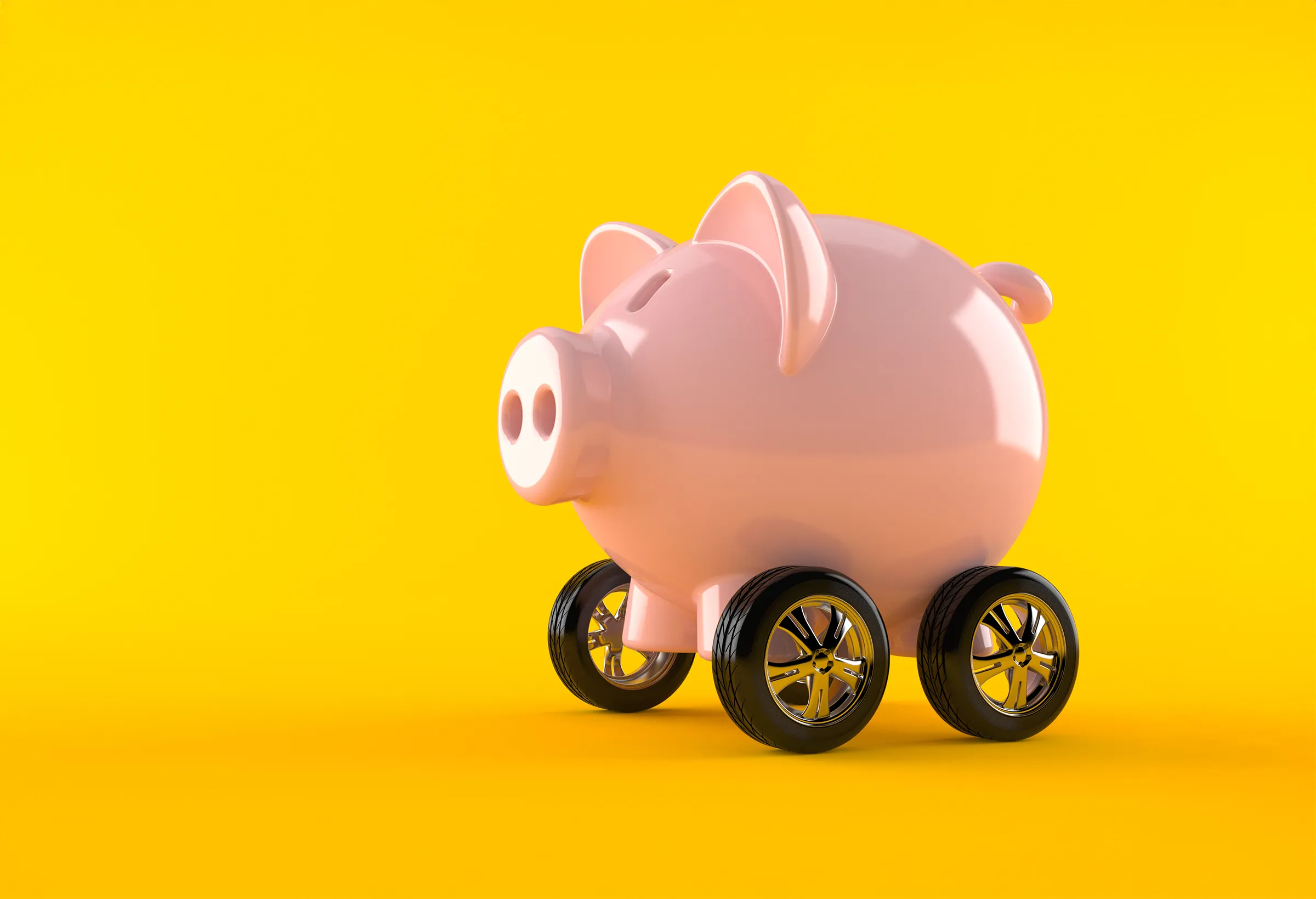 A pink plastic piggy bank on wheels.