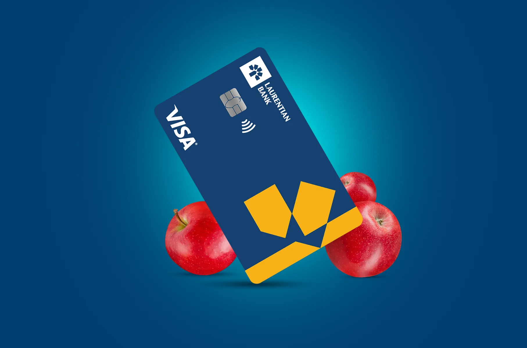 The Laurentian Bank Visa* Reduced Rate card surrounded by fresh, red apples.