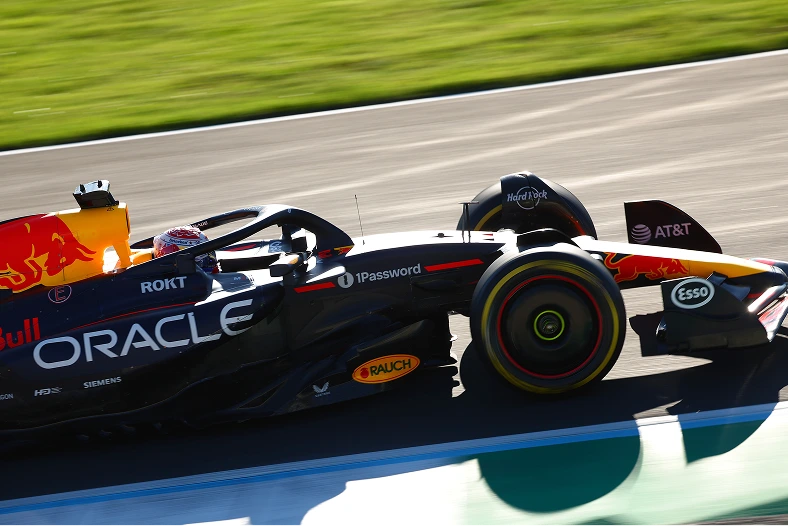 Close-up of the Oracle Red Bull Racing car in motion, featuring 1Password branding as the team balances speed, control, and security under intense racing conditions.