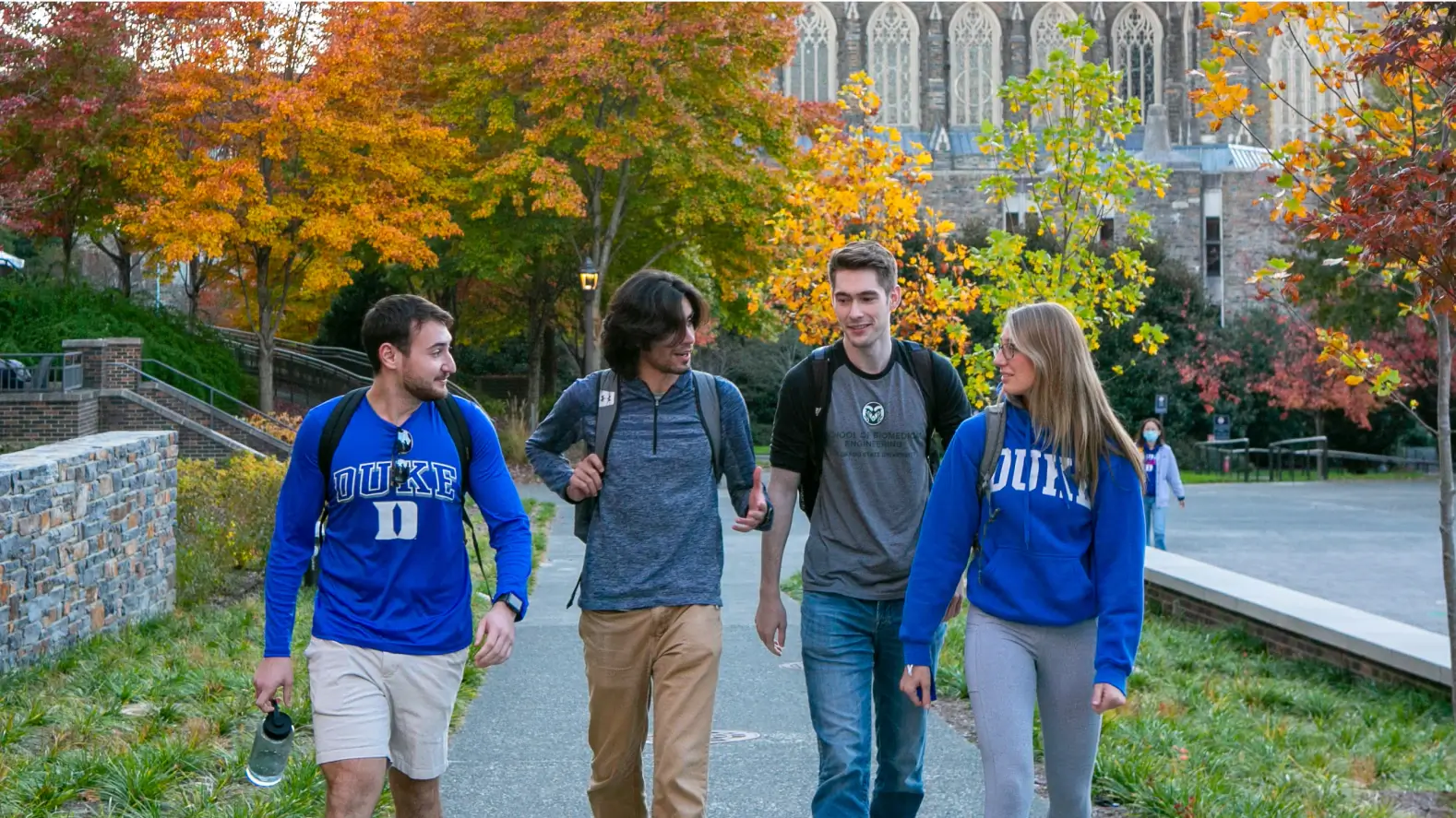 Duke students dressed in blue walking on campus