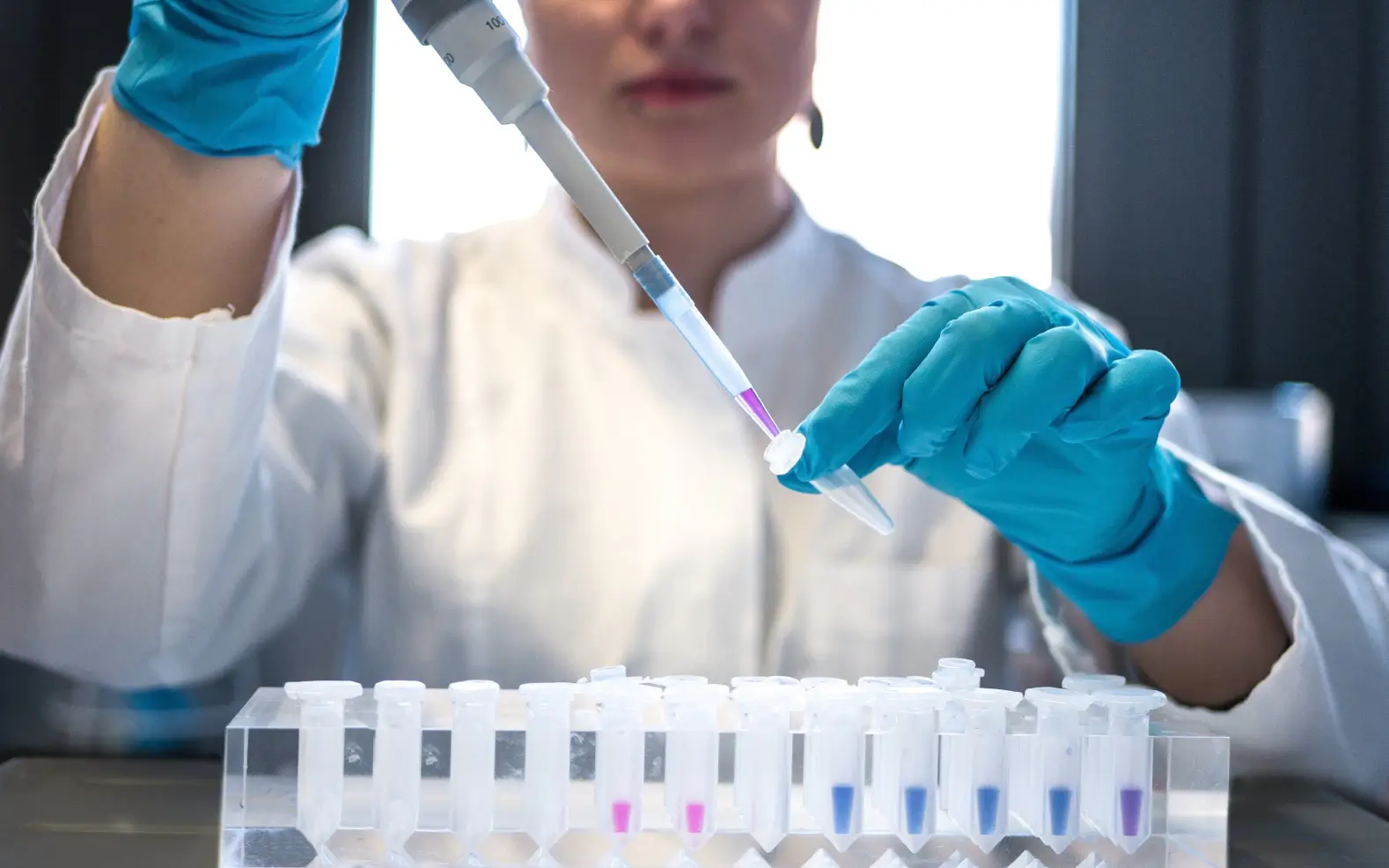 Frontiers team member wearing gloves in research lab