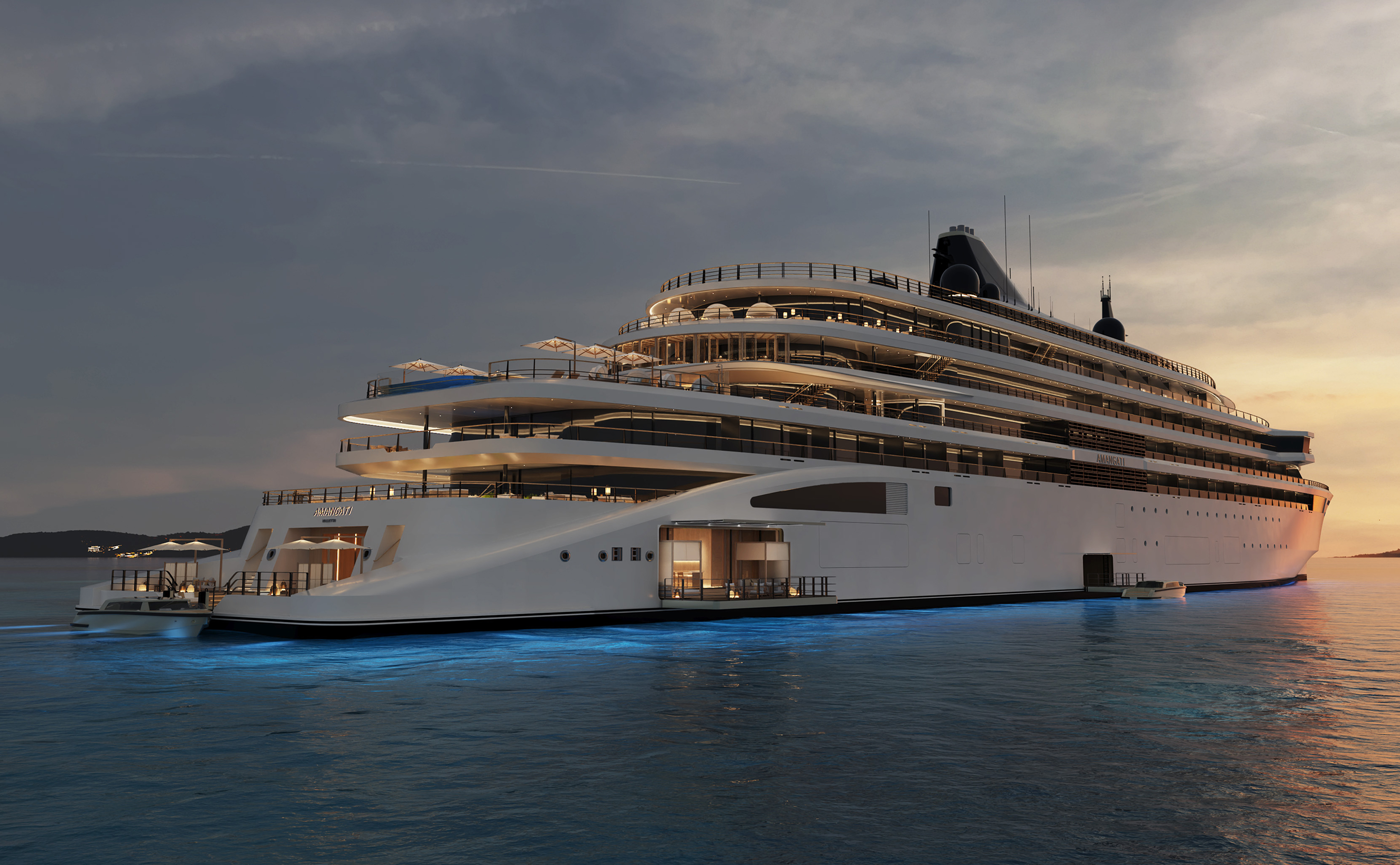Amangati luxury motor yacht illuminated at sea in the evening