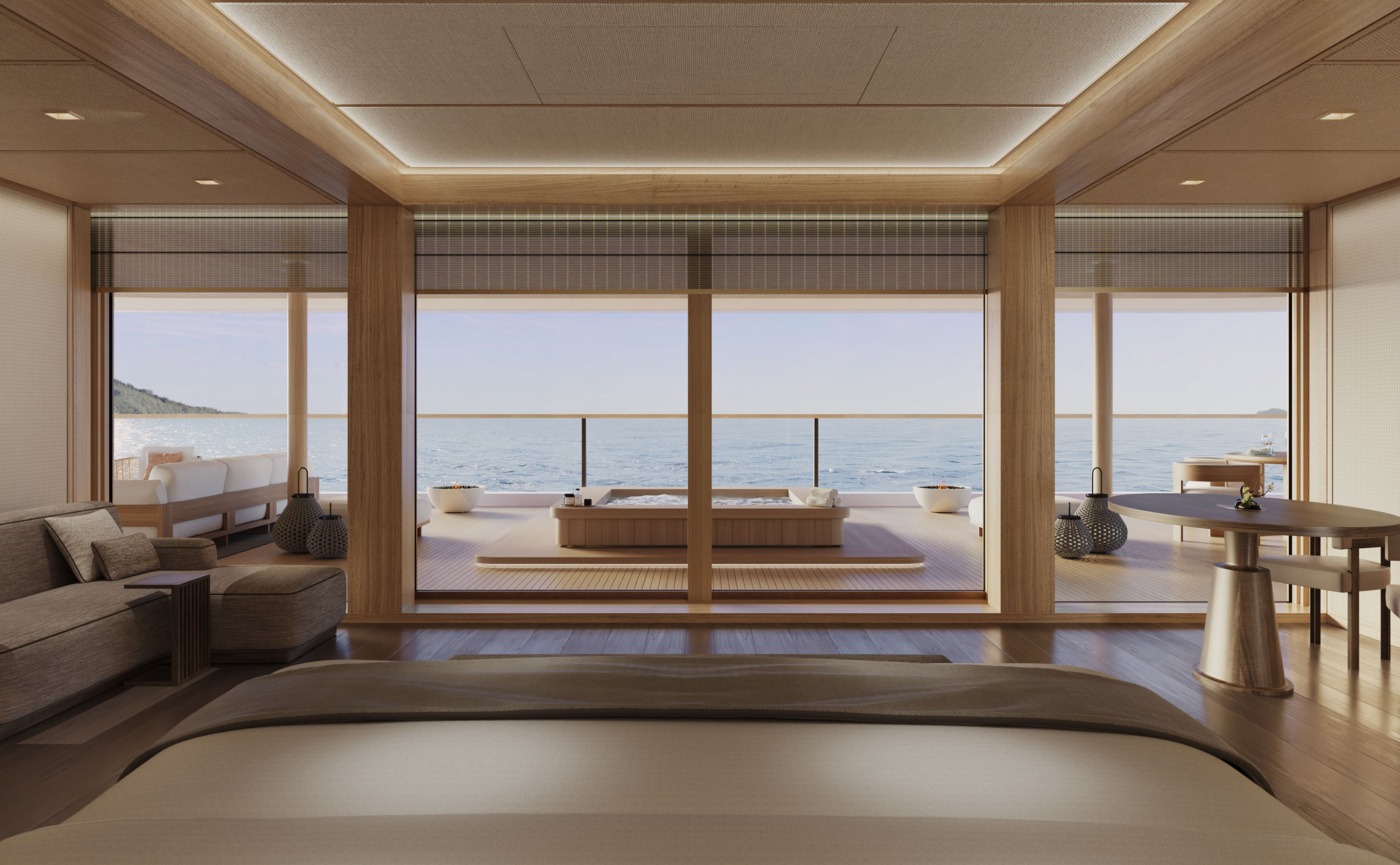 Spacious bedroom of the Aman Suite opening to a private whirlpool bath on the Amangati luxury motor yacht