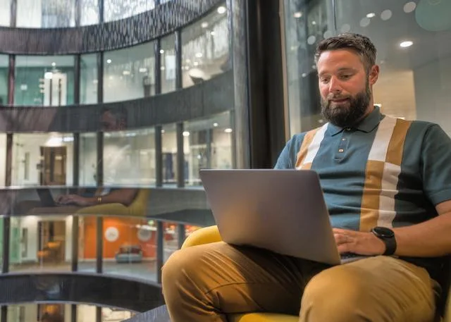 A man looking at a laptop How to find a financial advisor
