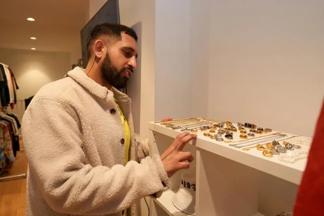 A man looking at jewelry in a store Finding a good jeweler