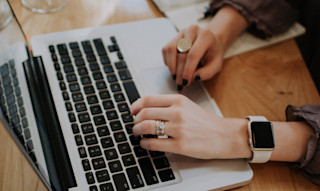Woman with Apple Watch typing on keyboard christin-hume-309876