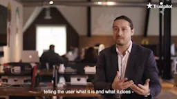 Man in office explaining something LoveBook x Trustpilot Case Study