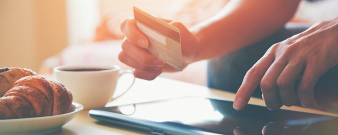 Creditcard and tablet person-at-table-with-credit-card-and-tablet