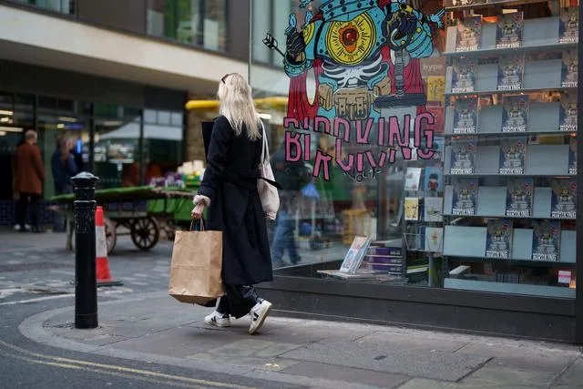 A woman walking along a street with a shopping bag Vegan beauty brands