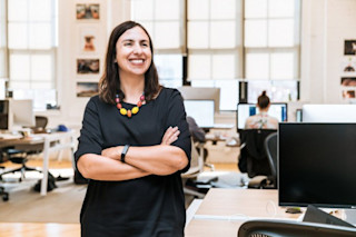 Woman smiling in office 5 online reputation management strategies for driving brand trust