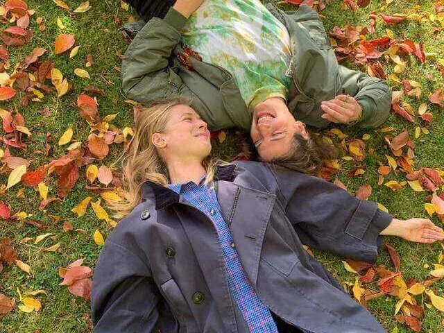 Two people lying down on grass better sleep