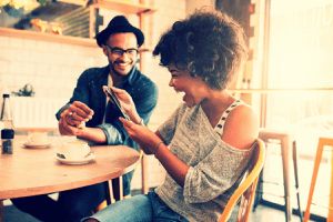 couple laughing and drinking coffee coffee shop