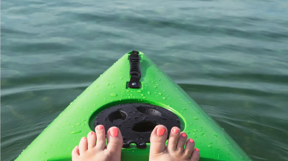Kayak travel image of woman's feet on kayak