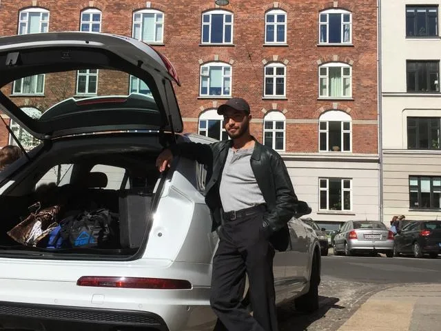 A man standing next to a car A guide to renting a car