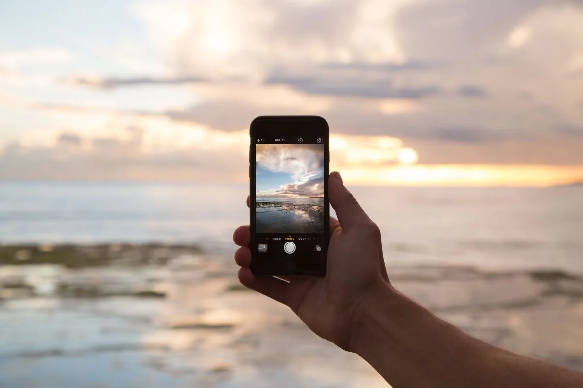 Mobile phone taking a picture of the sea