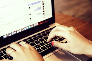 importance of reviews for ecommerce Woman typing on laptop