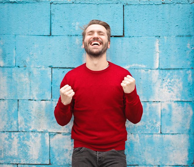 Man celebrating victory How great sites convert visitors to customers