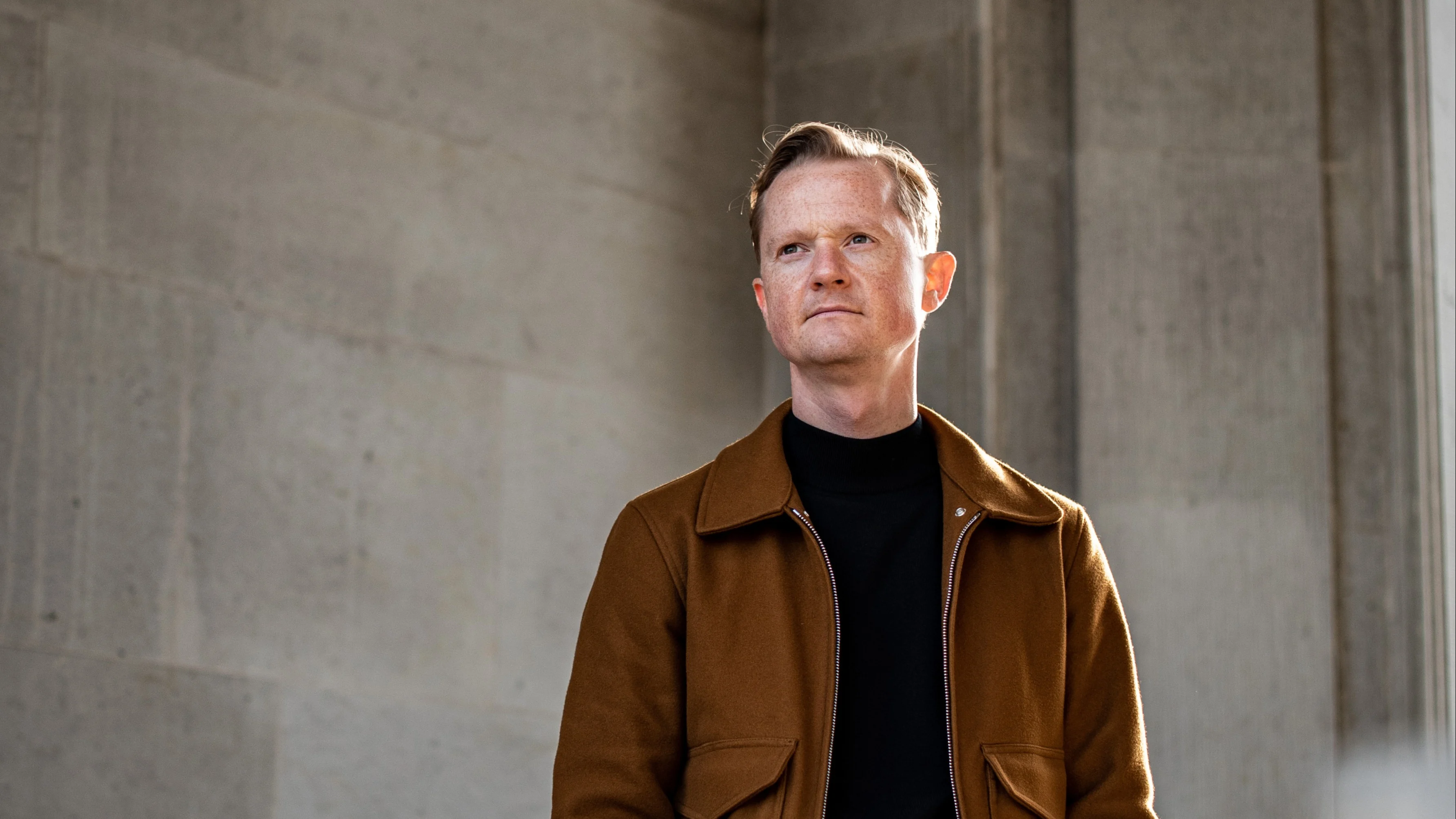 Peter Mühlmann, Founder and CEO, Trustpilot, in a brown jacket and black turtleneck