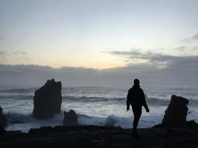 Silhouette of a person walking near the sea Your road trip checklist for a safe and memorable getaway