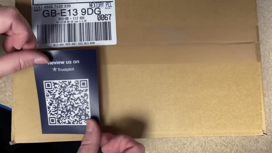 Trust Ambassadors QR code sticker 1000x562 Trust Ambassadors QR code sticker being put on a box