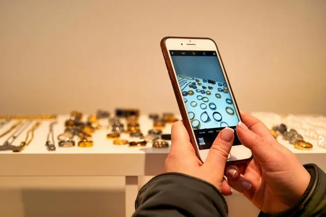 Someone taking a picture of jewelry on a shelf Buying ethical jewelry