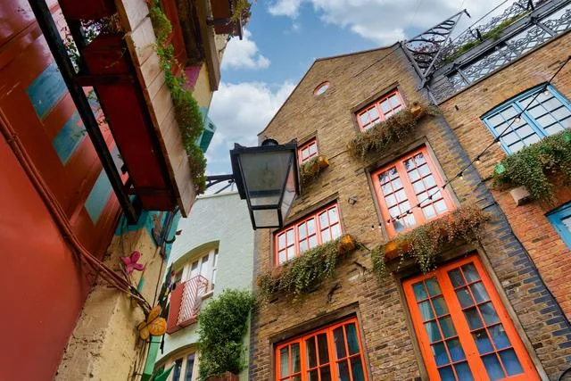 A three floor building with colorful wooden window frames Renting vs buying a home