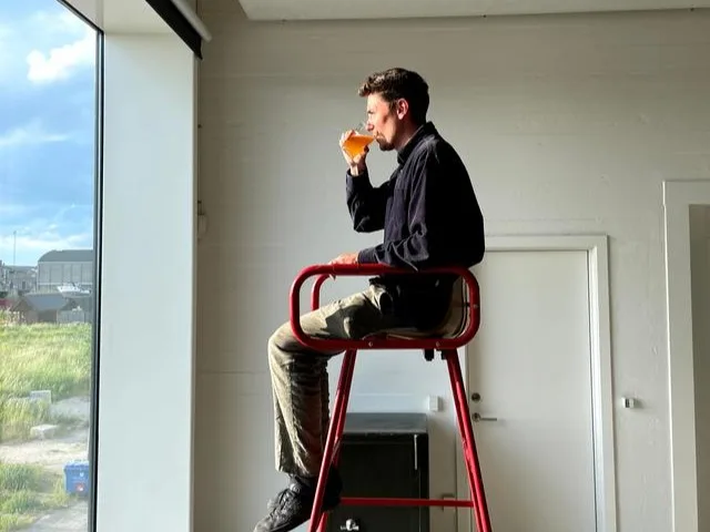 A man looking down at a laptop Real estate scams