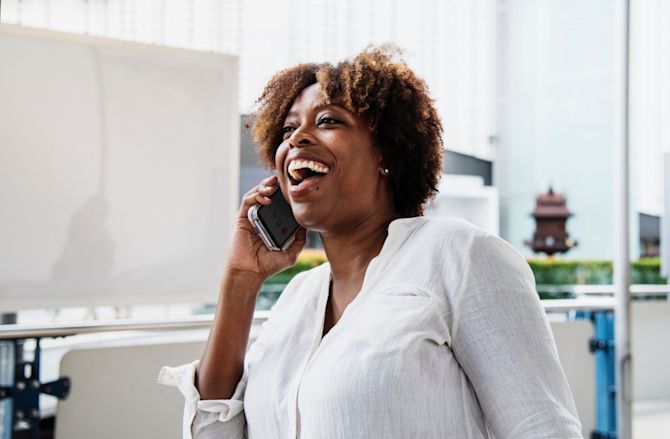 Woman laughing on phone Woman laughing