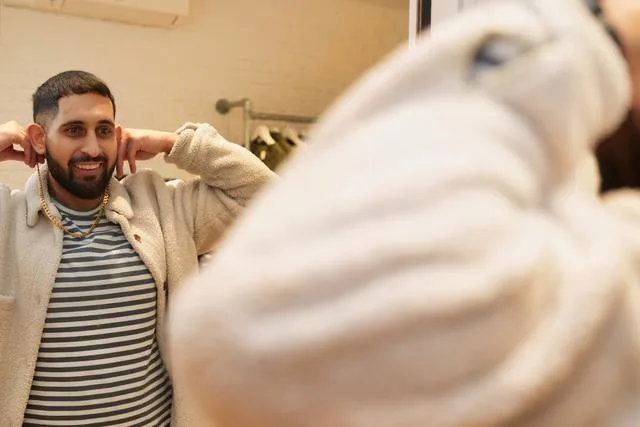 A man trying on a chain in a store Ethical jewelry guide