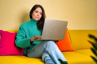 A woman looking at a laptop Holiday hoaxes to avoid