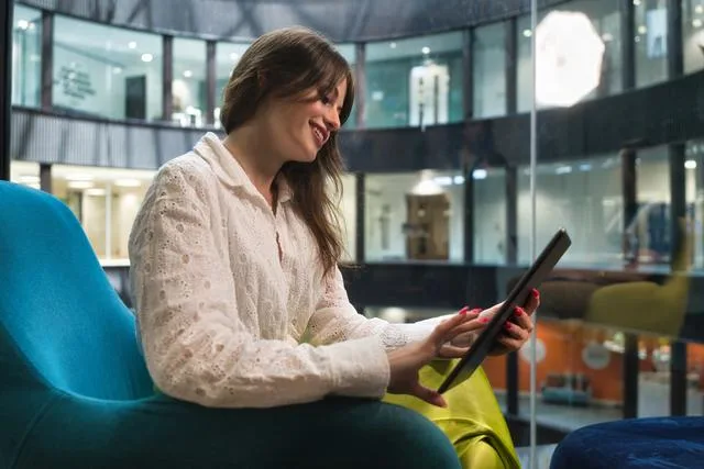 a woman looking at a tablet social media scam