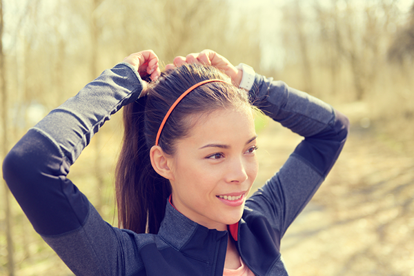 Woman tying hair up