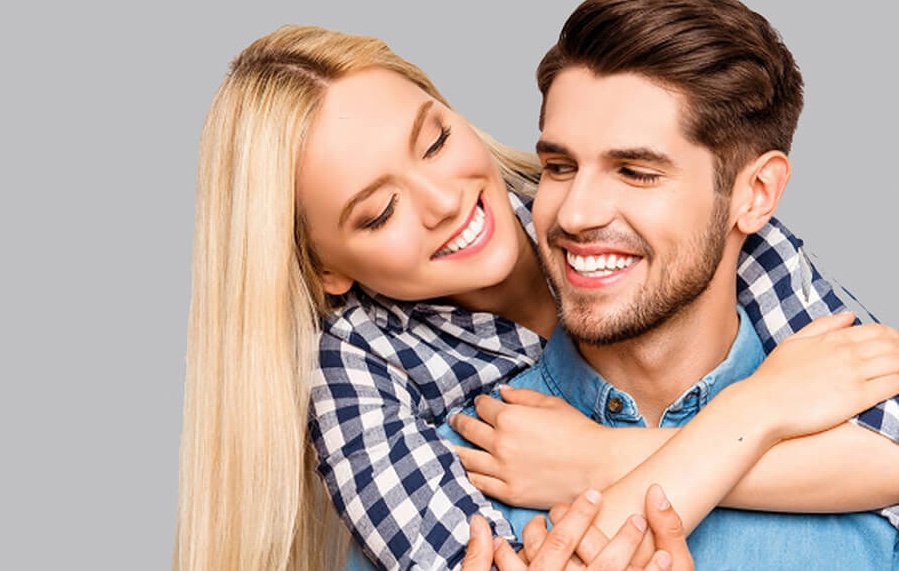 Man & woman, smiling, with healthy hair