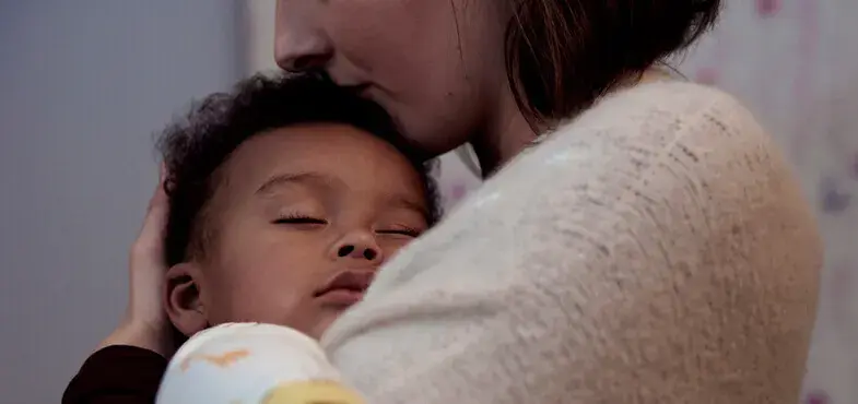 Johnson's Baby baby sleeping in arms image