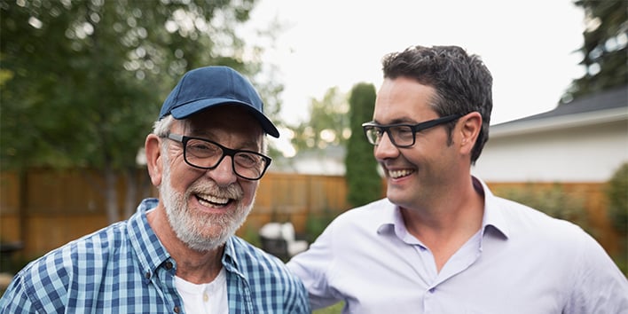 Two men at different ages smiling together