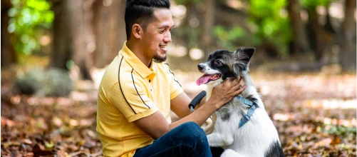 Man stroking a dog outdoors