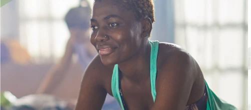 Woman riding an exercise bike indoors