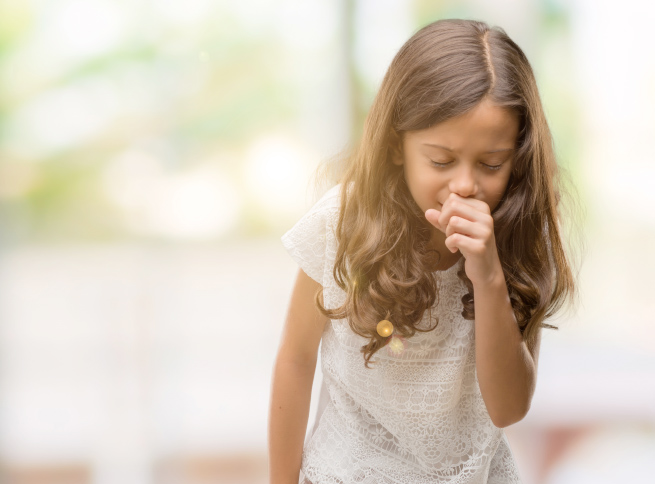 Child coughing into their hand