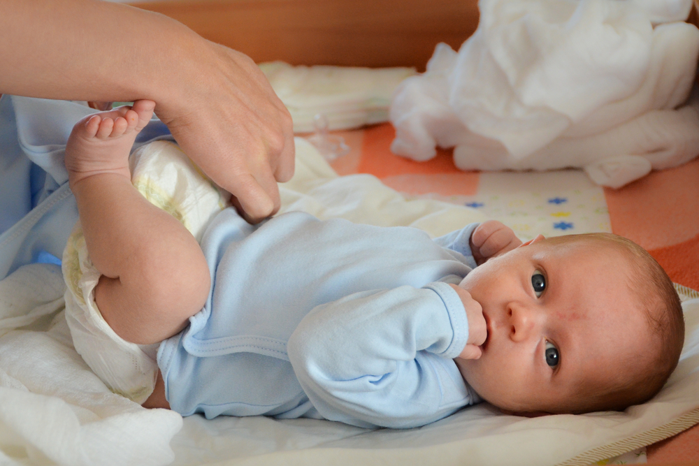 A baby getting its nappy changed
