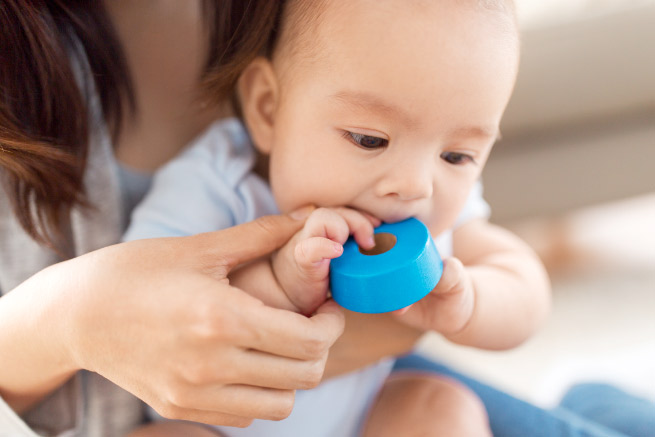 Baby with toy in mouth