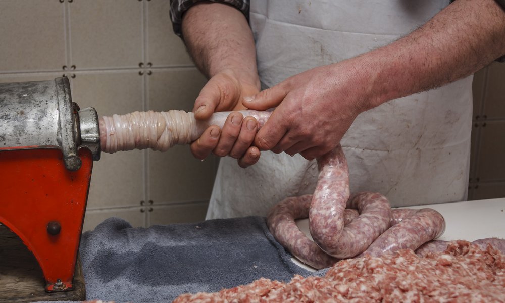 L'embossage de la saucisse : on remplit régulièrement le boyau avec la farce