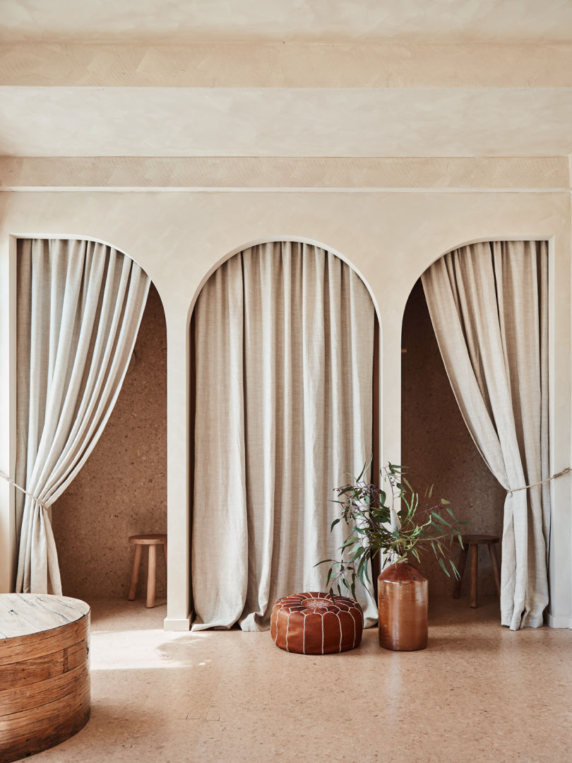 Pop up retail store_arched lime washed walls_linen curtain