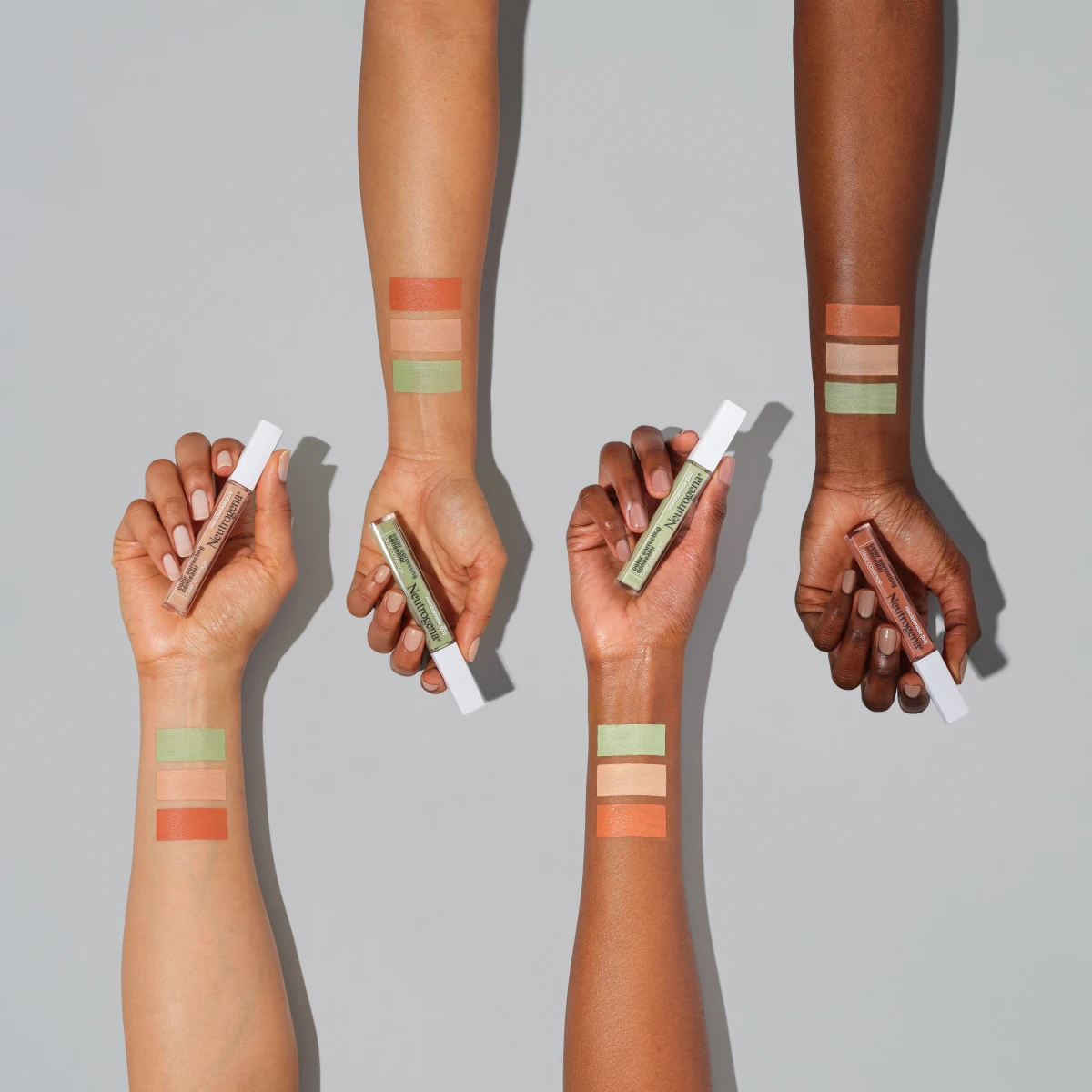 Four  arms showing Neutrogena® Clear Coverage Color Correcting Concealer swatch colors