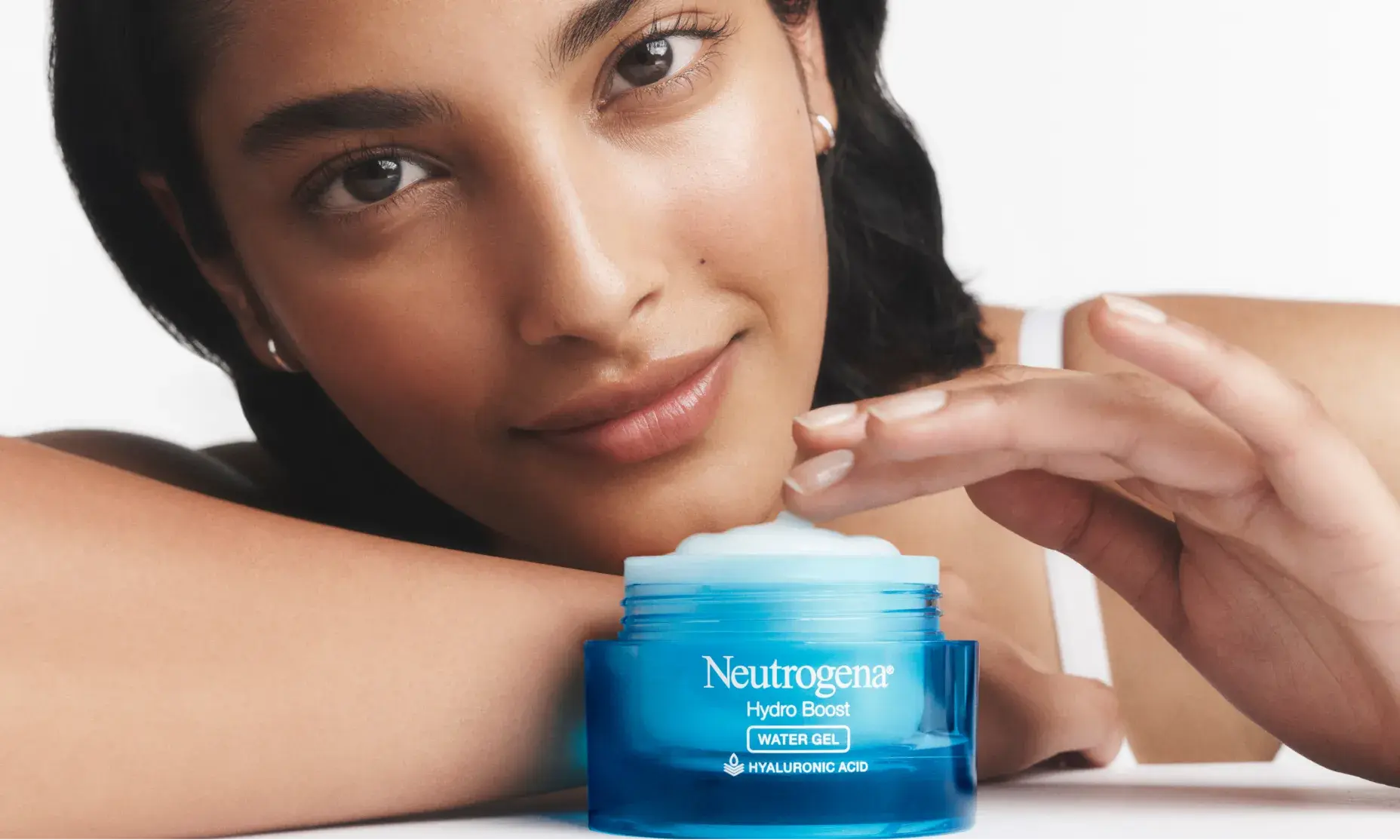 Woman applying Hydro Boost Gel Cream Moisturizer with an open jar