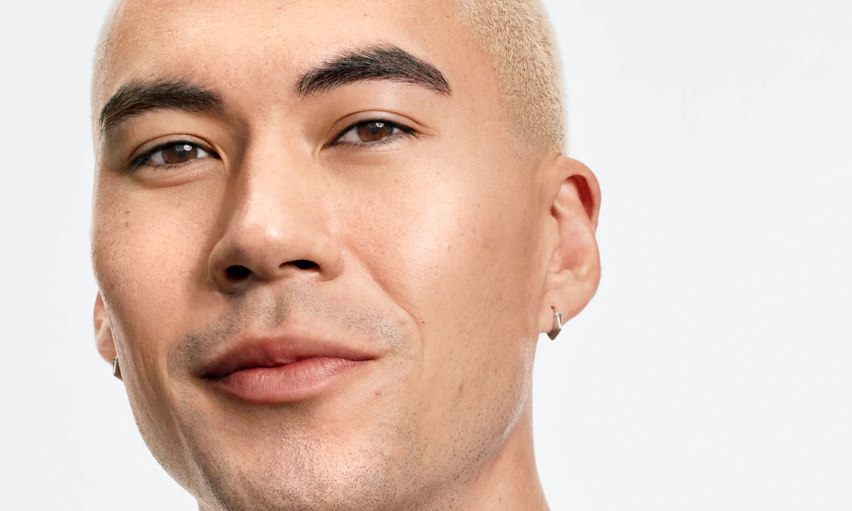 Man with clear skin and faded marks after using Neutrogena® Evenly Clear™ Acne Exfoliant